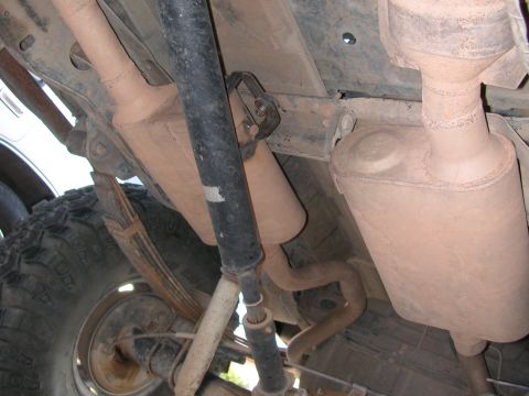 1984 Ford Bronco - Undercarriage of a vehicle, focusing on the exhaust system and suspension components.