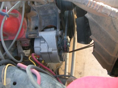 1984 Ford Bronco - This image shows a close-up view of an engine bay, focusing on the alternator and associated engine parts.