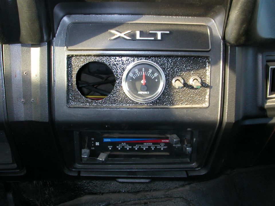 Interior dashboard with XLT badge, amp gauge, and climate controls