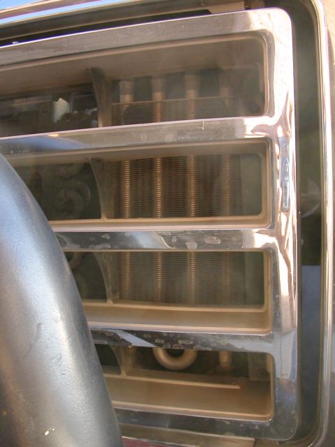 1984 Ford Bronco - Front grille detail of an early 1980s Ford Bronco, showing the radiator behind the chrome bars.