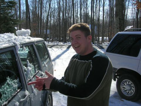 1993 Ford Probe - A man gestures towards a snow-covered vehicle, with another SUV visible in the background.