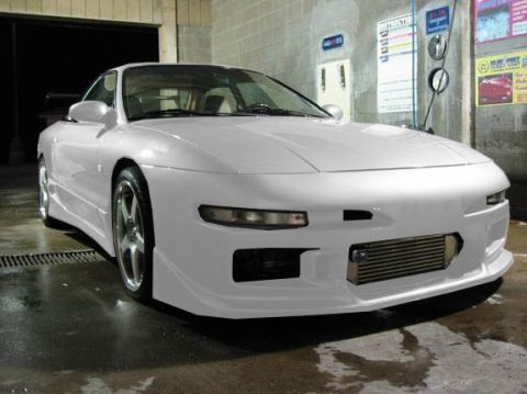 1994 Ford Probe - A white 1994 Ford Probe with custom bodywork sits in a car wash bay.