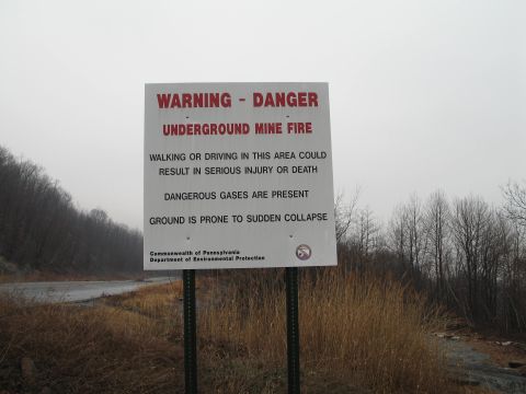 1995 Ford Bronco - A sign warns of dangers including underground mine fire, hazardous gases, and ground collapse in the area.