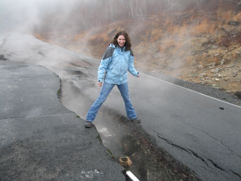 1995 Ford Bronco - A road is severely damaged with a large crack, and steam is rising from the ground.