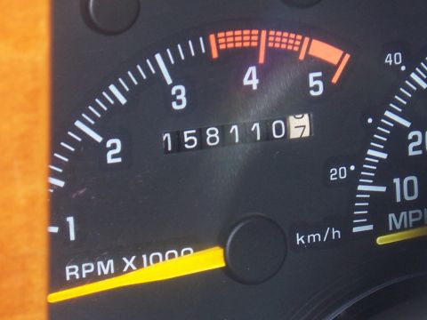 1992 Ford C-250 (Centurion Conversions) - Close-up of a vehicle's odometer and tachometer gauges.