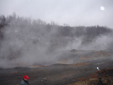 1979 Ford Bronco - A person in a red hat stands in a misty, industrial-looking landscape with bare trees.