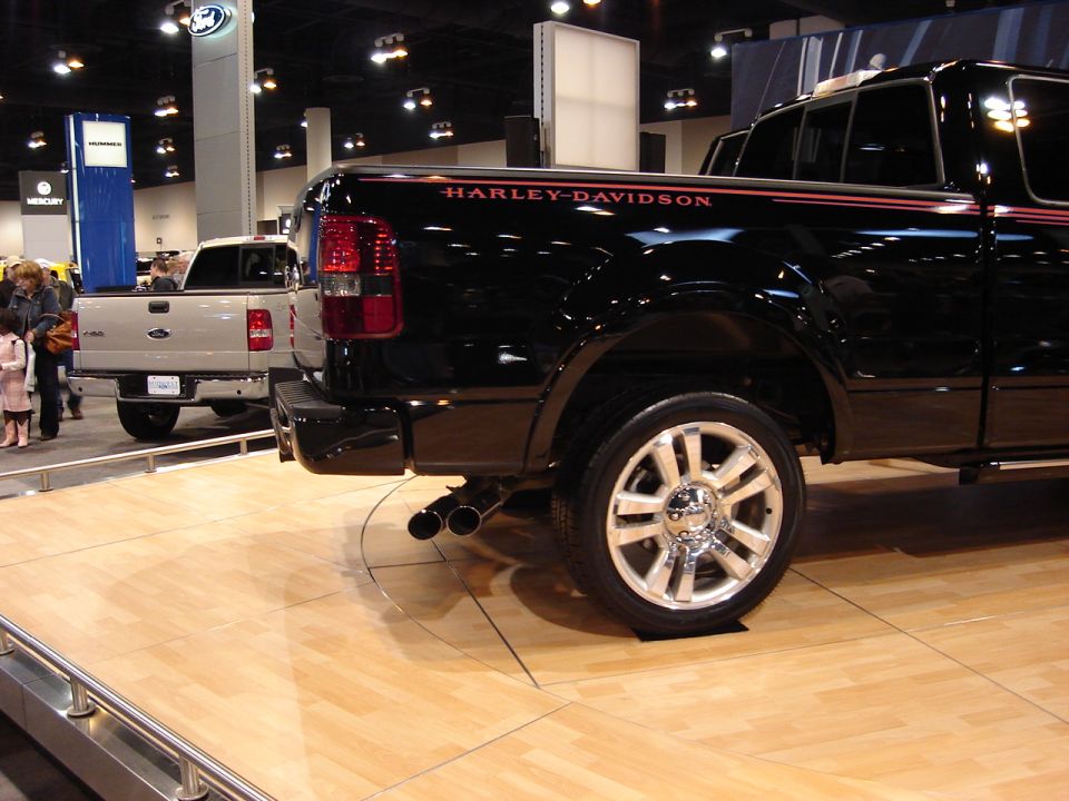Black pickup truck rear view with Harley-Davidson badging and dual exhaust