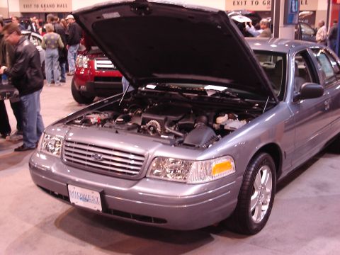 2000 Ford Crown Victoria - 2000 Ford Crown Victoria displayed with its hood open at an auto show.