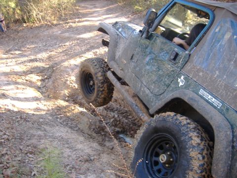 1999 Jeep Wrangler - Jeep Wrangler navigating a challenging muddy off-road course.