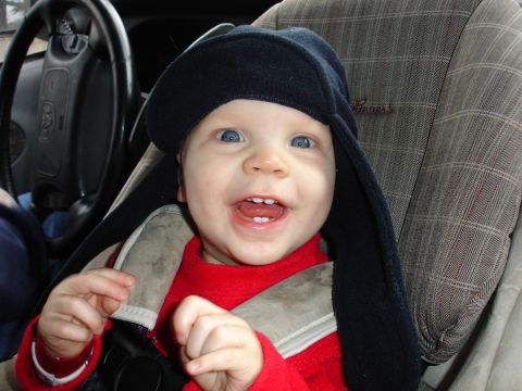 1989 Ford Bronco - A happy baby is secured in a car seat, ready for a drive.