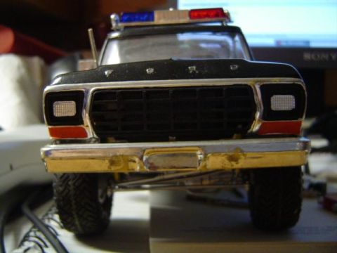 1979 Ford Bronco - Close-up of a model police truck's front end, showing the grille and bumper details.