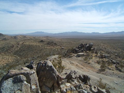 1988 Ford Bronco - A wide view of a dry, arid landscape with hills and mountains under a partly cloudy sky.