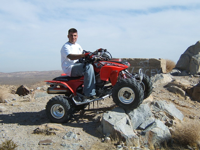 Red Honda ATV on rocky terrain
