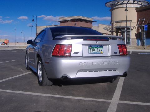 2003 Ford Mustang - Rear view of a silver 2003 Ford Mustang GT with a spoiler and GT badging.