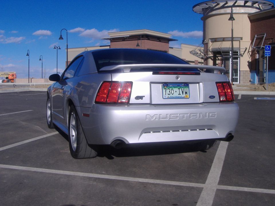 Silver 2003 Ford Mustang GT parked in a lot, rear view