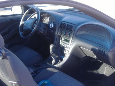 2003 Ford Mustang - Interior view of a 2003 Ford Mustang, showing the dashboard, steering wheel, and seats.