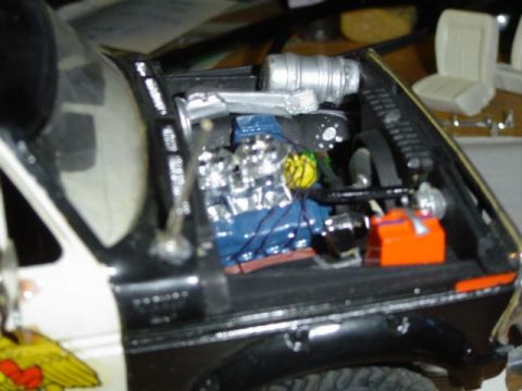 1979 Ford Bronco - Close-up of a model car's engine bay, showing intricate details of the engine components.