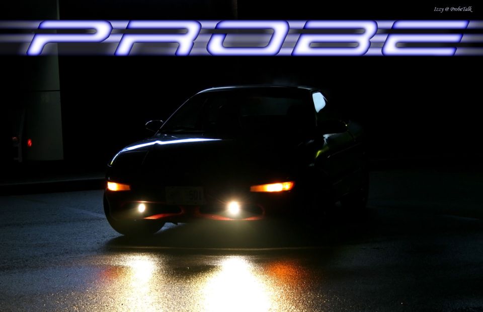 Dark Ford Probe coupe at night on wet pavement with PROBE graphic banner overlay