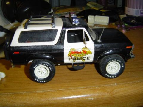 1979 Ford Bronco - Model police car resembling a 1979 Ford Bronco, complete with police decals and light bar.