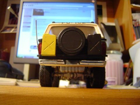 1979 Ford Bronco - A toy police SUV is viewed from the rear, equipped with a spare tire and two jerrycans.