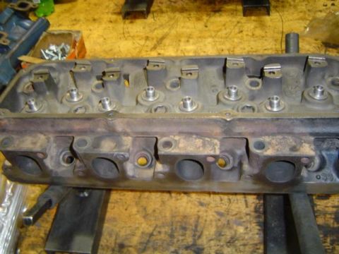 1979 Ford Bronco - A close-up view of an engine cylinder head, showing its internal components and ports.