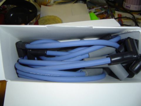 1979 Ford Bronco - A box of blue spark plug wires, some marked with 'RACING', are neatly arranged.