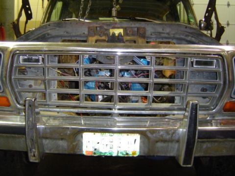 1979 Ford Bronco - Front view of a 1979 Ford Bronco undergoing engine work, showing the grille and exposed engine components.