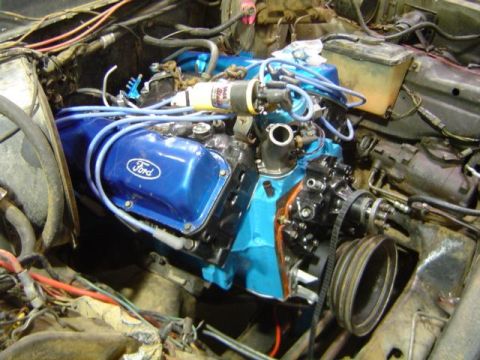 1979 Ford Bronco - Close-up of a Ford V8 engine during a rebuild, with blue painted components and visible wiring.