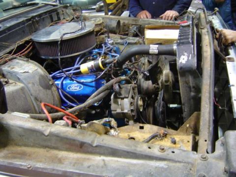 1979 Ford Bronco - Close-up of an engine bay blue Ford valve covers and a prominent air filter assembly.