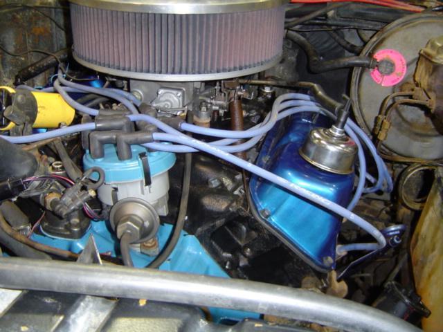 Engine bay with blue valve covers, large air filter, and distributor
