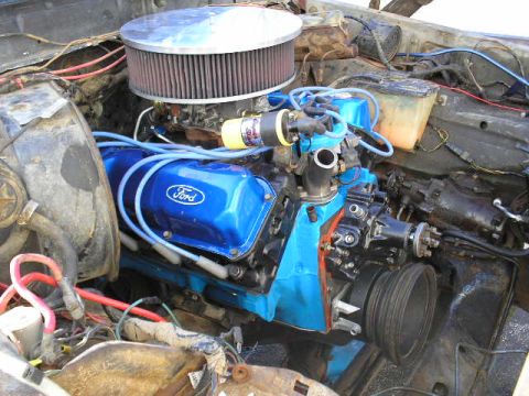1979 Ford Bronco - Close-up view of an engine bay blue Ford valve covers and an aftermarket air filter.
