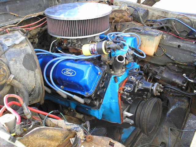 Engine bay with blue Ford valve covers and air filter