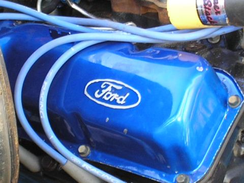 1979 Ford Bronco - Close-up of a blue Ford valve cover with spark plug wires, part of an engine rebuild.