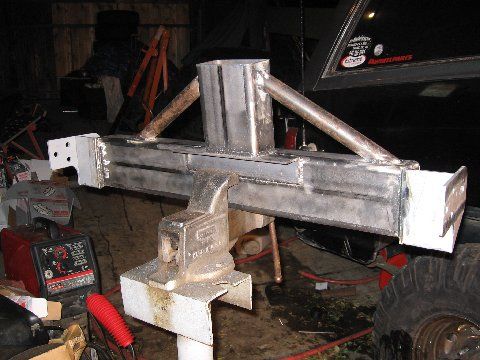 1988 Ford Bronco - Custom bumper fabrication in progress, held securely in a vise with welding equipment visible.