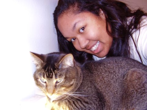 1997 Ford Taurus - A woman poses for a selfie with her cat in front of her.