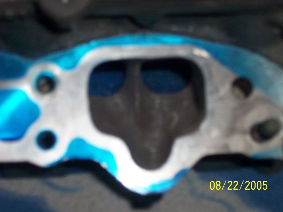 Cylinder head exhaust port with blue layout dye and bolt holes, dated 08/22/2005