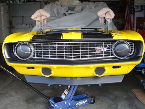 1970 Chevrolet Camaro - A yellow 1970 Chevrolet Camaro Z28 is shown from the front, lifted on a jack.
