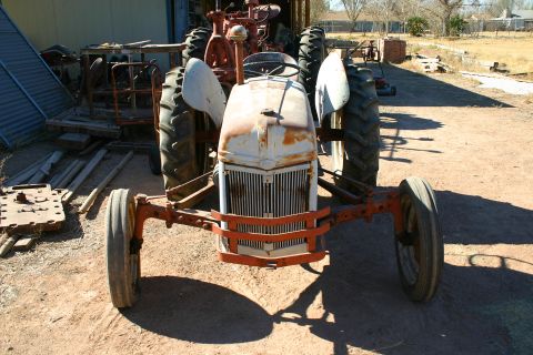 1981 Ford F-150 - This tractor, possibly a Ford, is seen from the front with its large rear tires and orange front axle prominent.