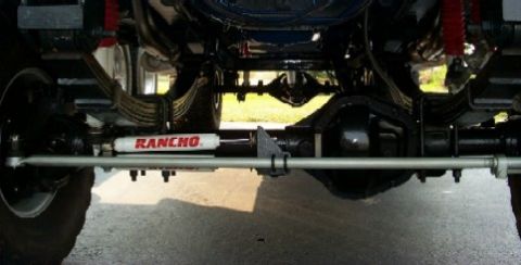 1979 Ford F-250 - The underside of a truck shows its suspension components and a Rancho steering stabilizer.