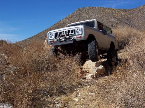 1981 Ford F-150 - An International Scout II navigates rocky terrain on an off-road trail.