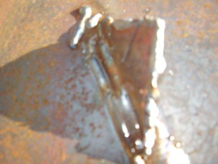 2004 Aston Martin Virage - Close-up of a section of metal showing welding marks and signs of rust.