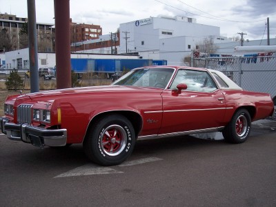 1972 Ford Ranchero - This red 1973 Pontiac Grand Am coupe features a white vinyl roof and distinctive front-end styling.