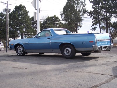 1972 Ford Ranchero - A blue 1972 Ford Ranchero is parked outside with trees and a utility pole in the background.