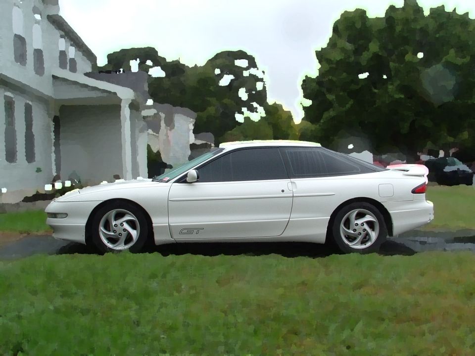 White 1996 Ford Probe GT coupe parked on grass, side view