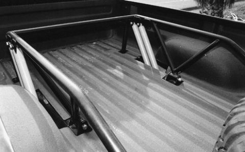 1984 Ford Bronco - Interior view of a truck bed with a custom roll cage installed.