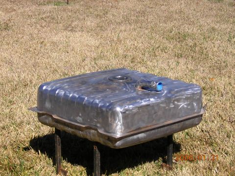 1986 Chevrolet Blazer - A metal fuel tank sits on a stand in a grassy outdoor area.
