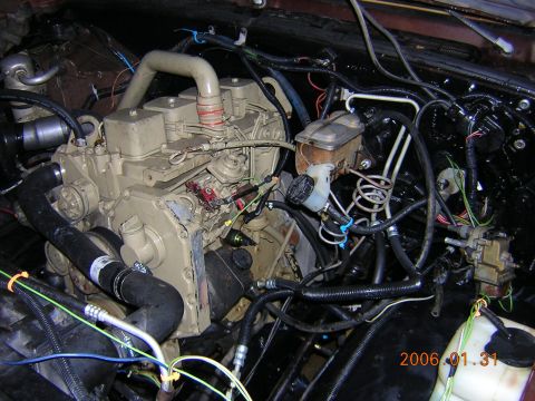 1986 Chevrolet Blazer - The engine bay shows a large diesel engine, likely a Cummins, with extensive wiring and plumbing.