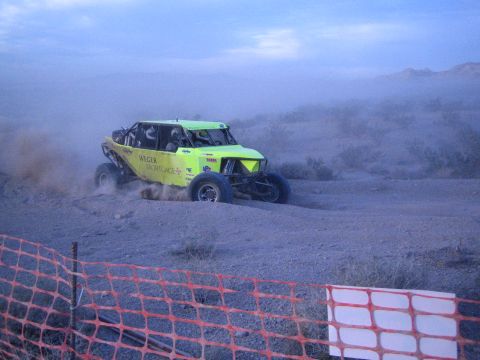 Green Weger Mortgage off-road race buggy on dusty desert course
