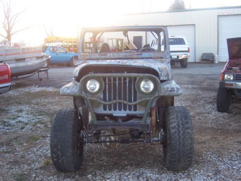 1992 Ford C-250 (Centurion Conversions) - This Jeep CJ-5 features a distinctive front end with a custom grille and off-road tires, seen in an outdoor lot with other vehicles.