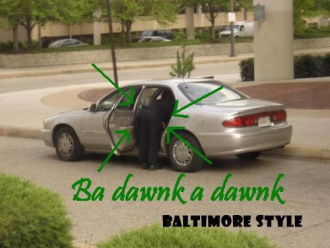 1999 Ford Taurus - A silver sedan is parked with its rear doors open, and a person is bending into the driver's side.